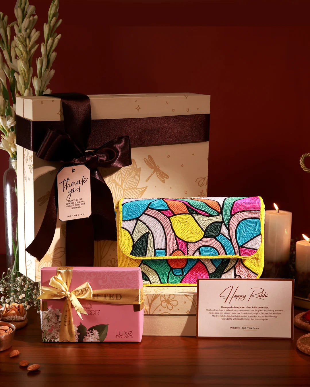 Luxury Rakhi Hamper with handcrafted colorful beaded Shoulder bag, premium chocolates, festive gift box tied with satin ribbon, thank you tag, and Raksha Bandhan greeting card – THE TAN CLAN