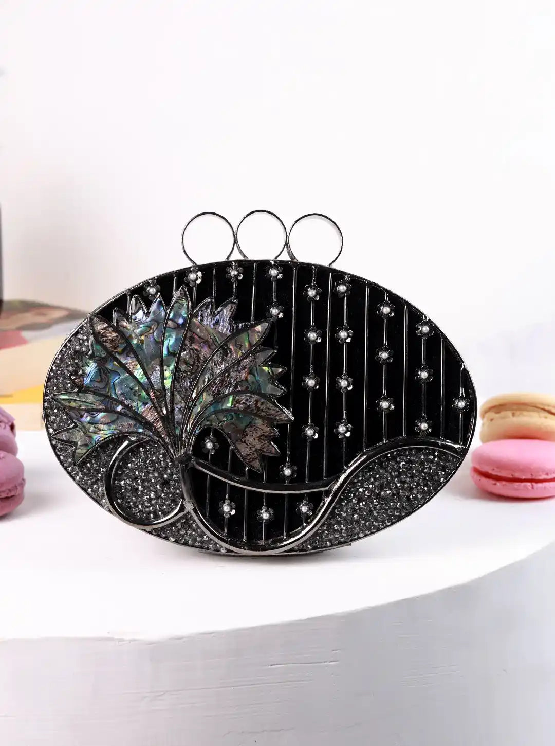 Black decorative plate with floral design on a white surface