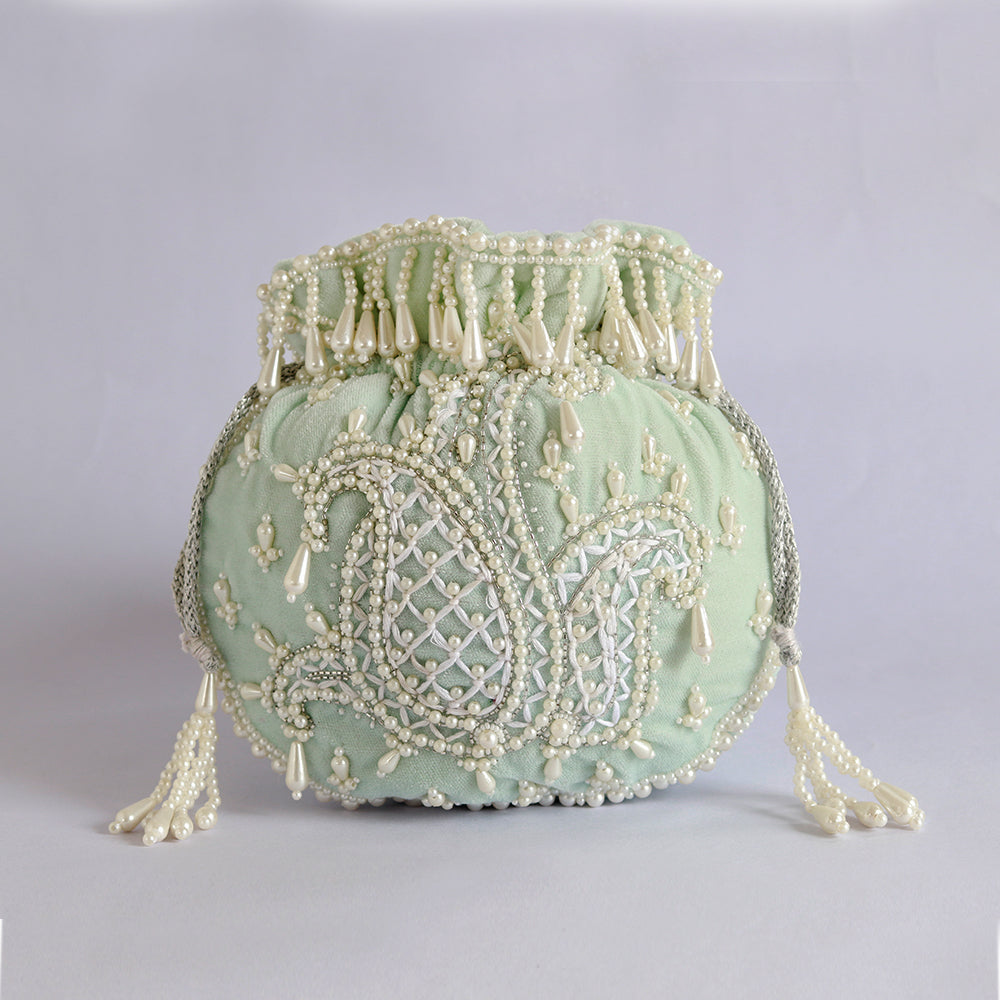 Blue Sukoon hand-embroidered potli bag with pearl handle from The Tan Clan, featuring intricate embroidery and elegant design.