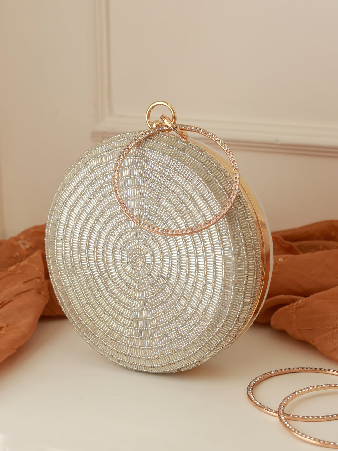 Silver round clutch purse by The Tan Clan featuring a sleek design and metallic finish, perfect for evening and special occasions.