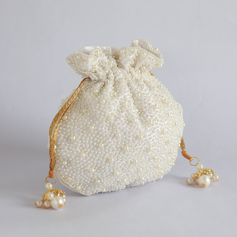 Elegant pearl potli bag with handle by The Tan Clan, featuring intricate pearl detailing and traditional embroidery.