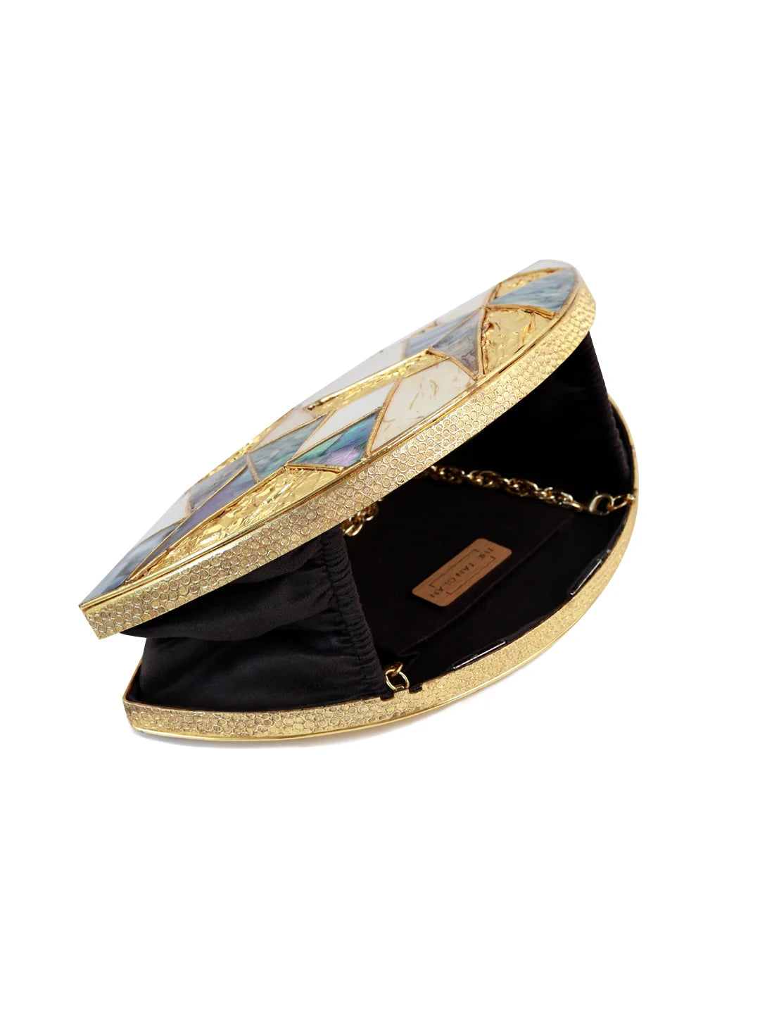 Round gold clutch with decorative lid on a white background
