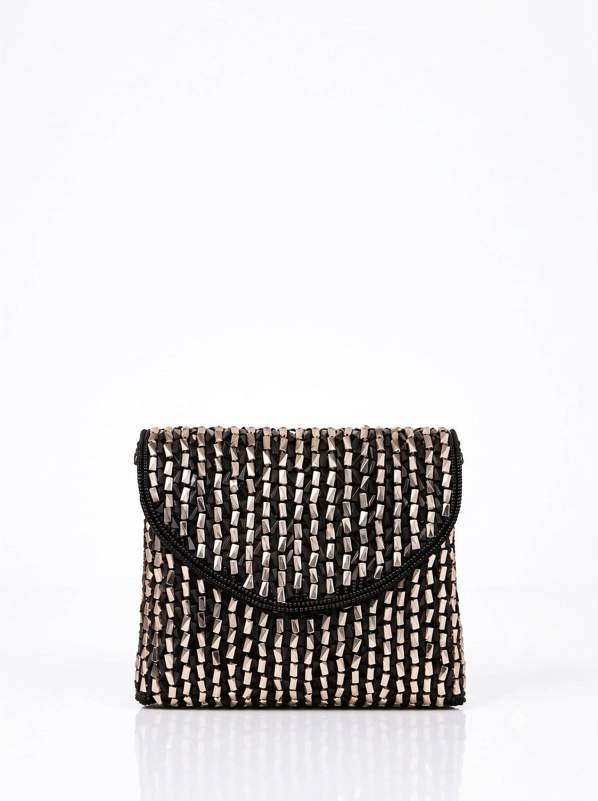 Anaya black envelope bag by THE TAN CLAN featuring a sleek, minimalist design with a flap closure and compact size.
