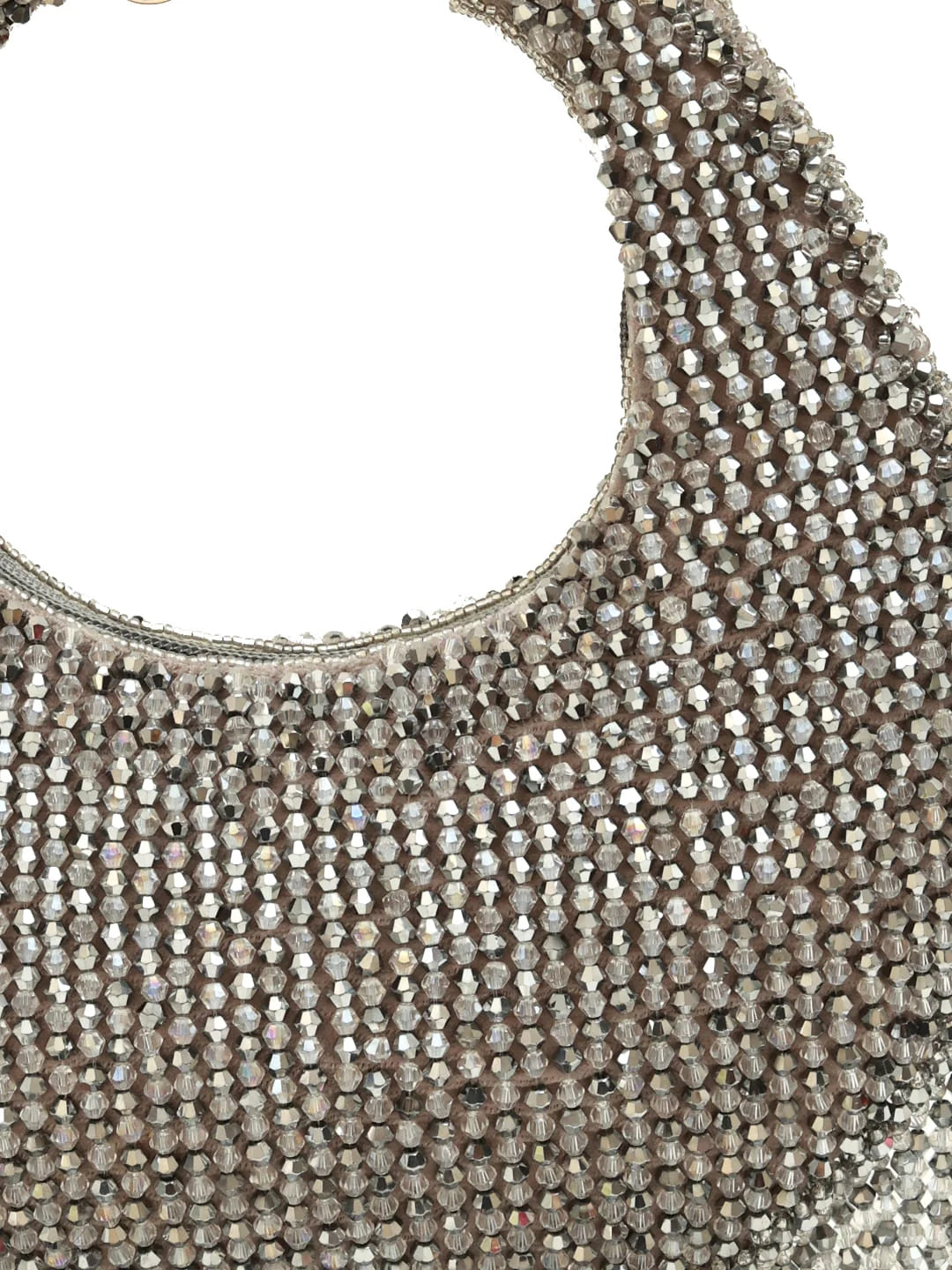 Close-up of a silver beaded handbag on a white background
