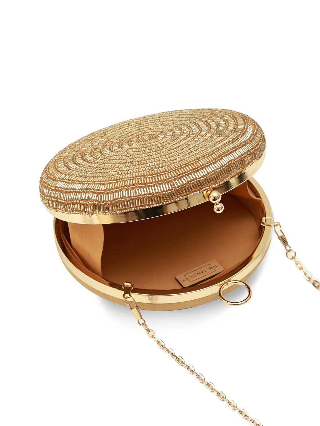 Gold clutch with intricate design on a white background
