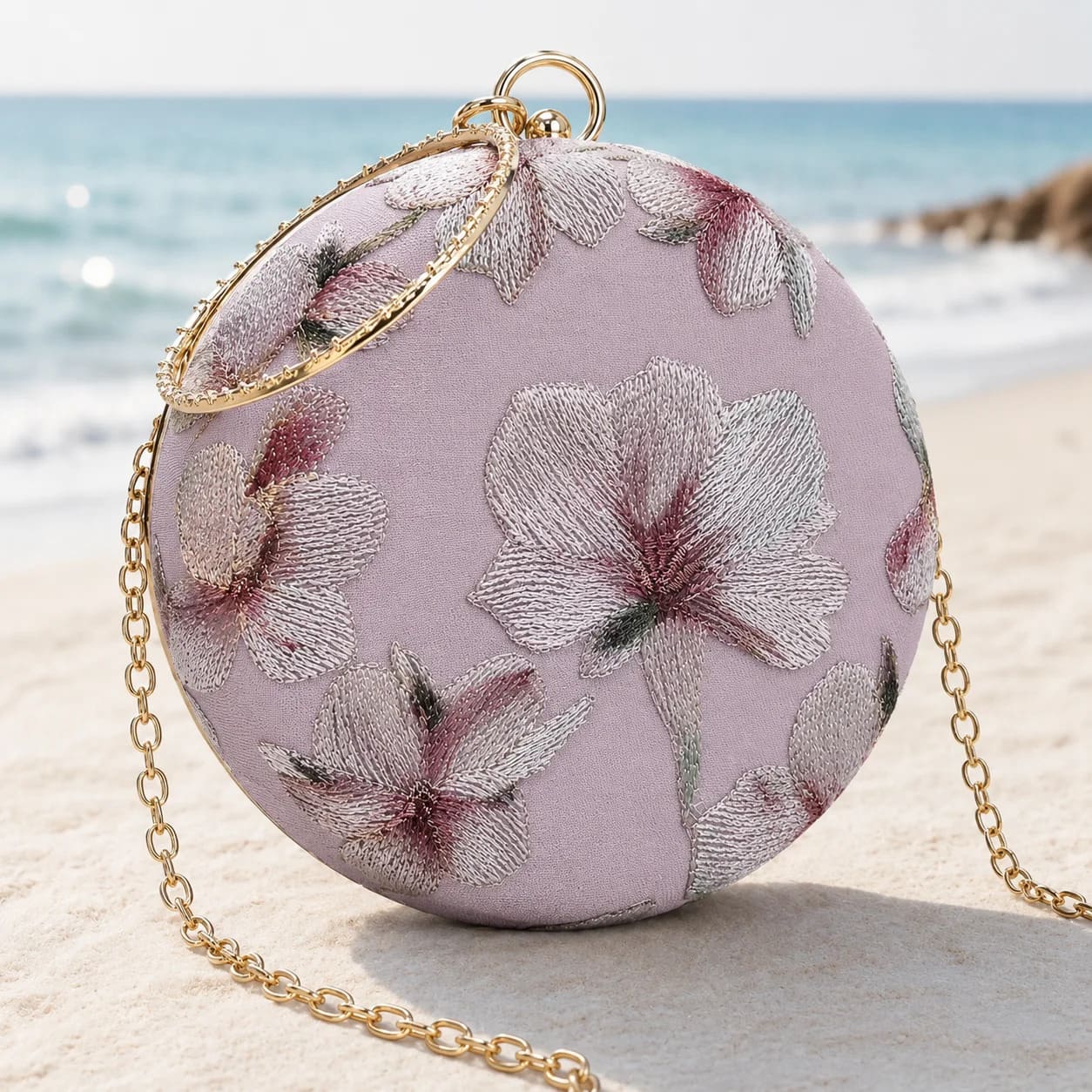 Mauve embroidered clutch bag from The Tan Clan with floral detailing, stylish accessory for evening or special occasions.