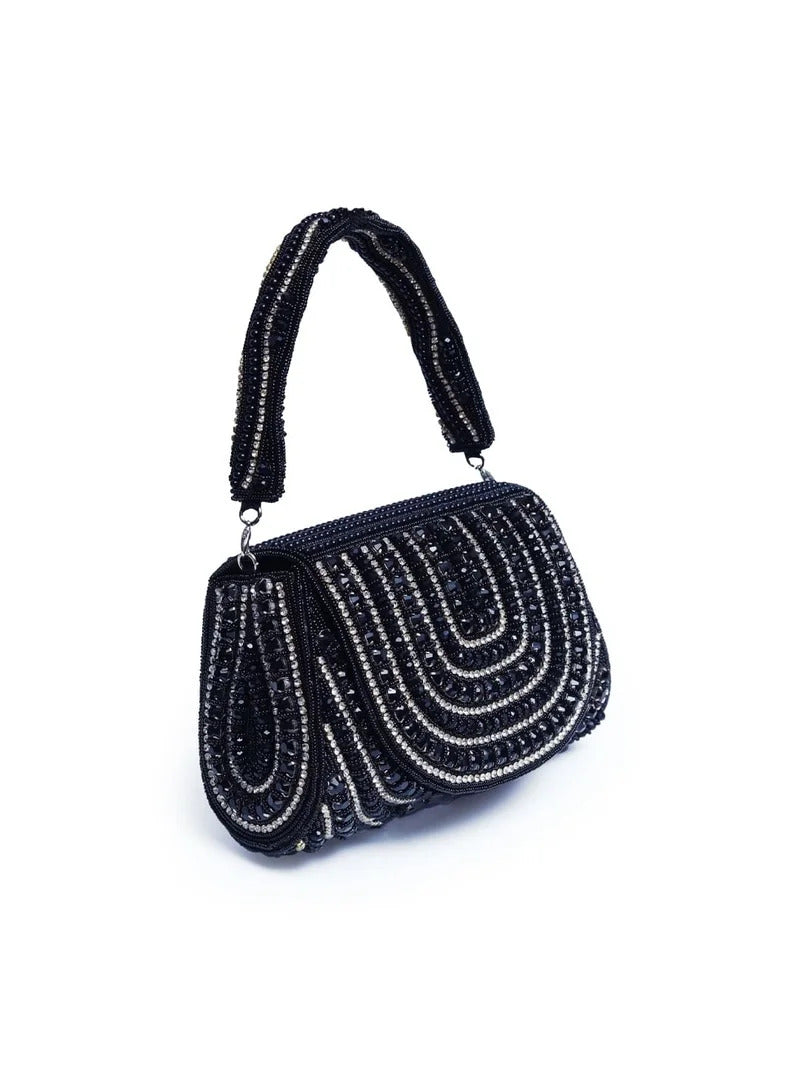 Black Chloe flap-over bag with handle, featuring sleek design and front flap closure, by The Tan Clan.