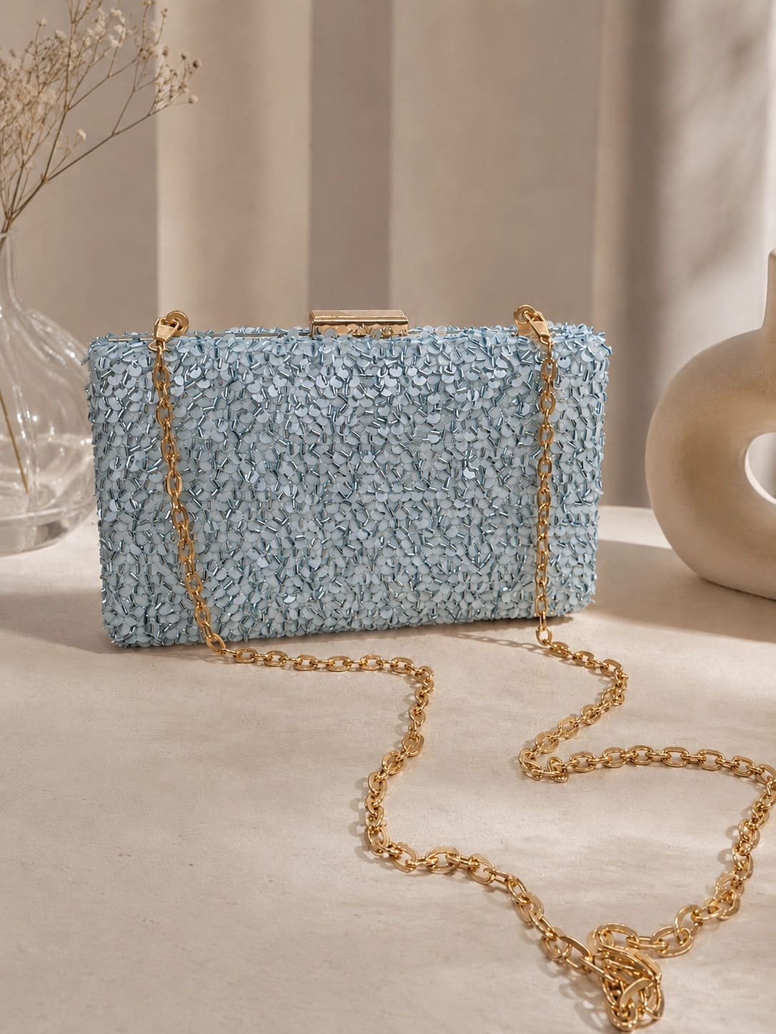 Dazzle Blue Sequined Sleek Clutch by The Tan Clan showing a shiny, blue sequined evening bag with a slim, elegant design.