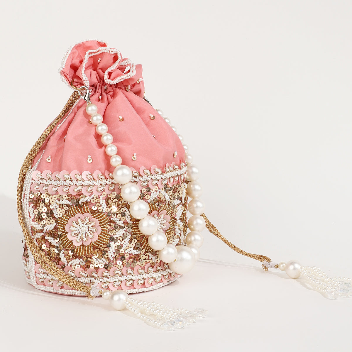 Ama Potli bag with pearl handle by The Tan Clan, featuring intricate embroidery and a luxurious, decorative design.