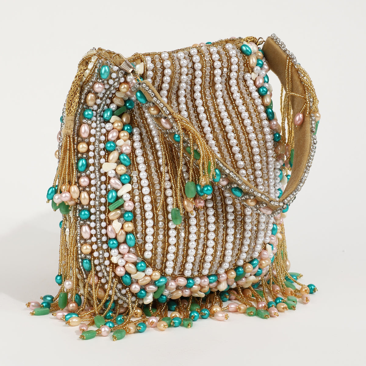 Sona Potli bag with handle from The Tan Clan, featuring traditional embroidery and a decorative tassel, on a neutral background.