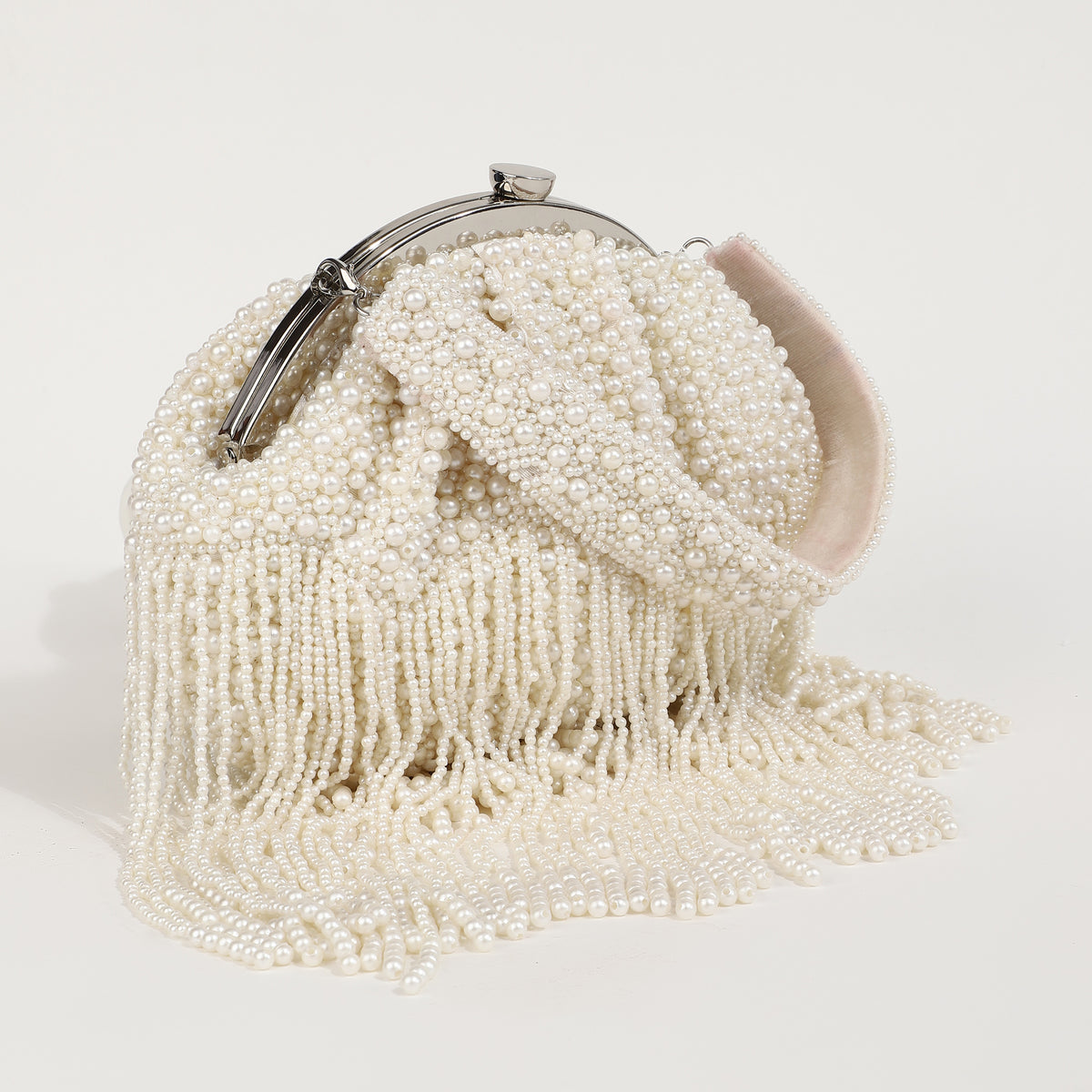 Pearl Batua bag with tassels from The Tan Clan, showcasing intricate design and decorative pearl embellishments.