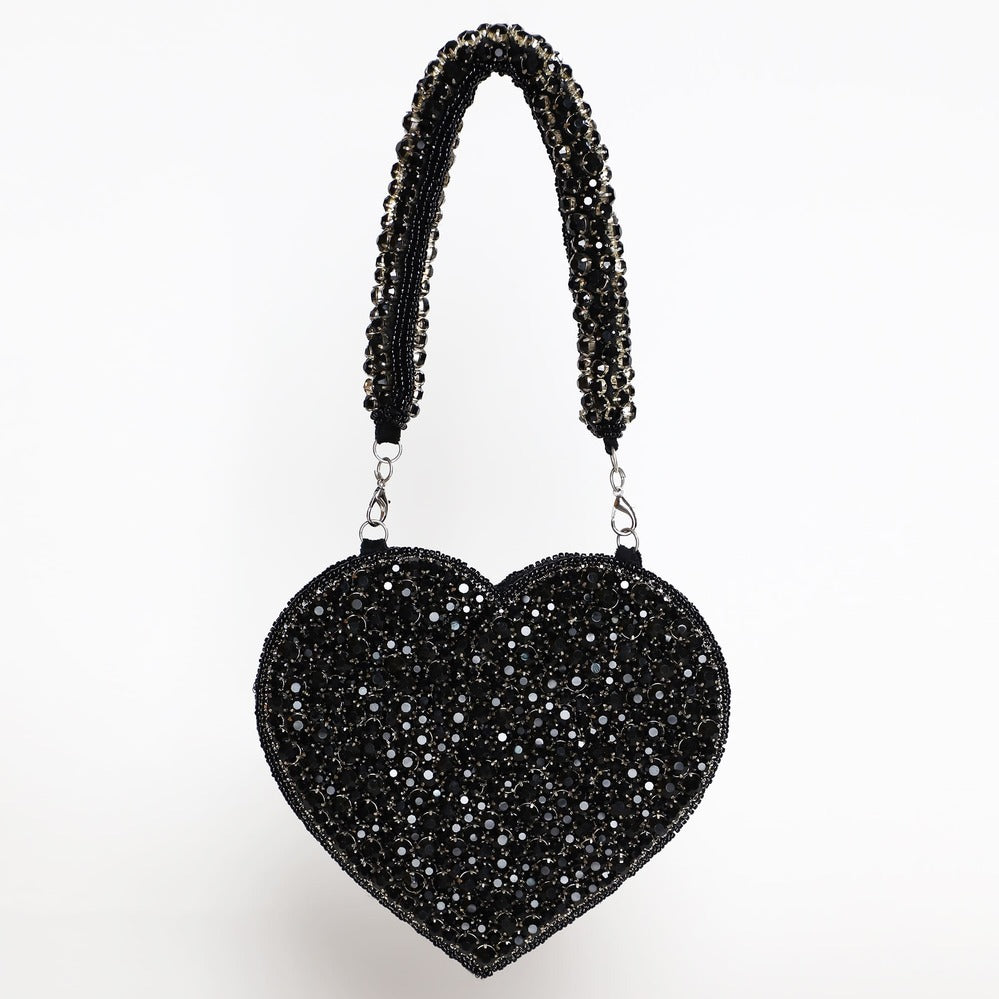 Black Scarlett Mini Heart Bag by The Tan Clan featuring a small heart-shaped design and a compact, stylish appearance.