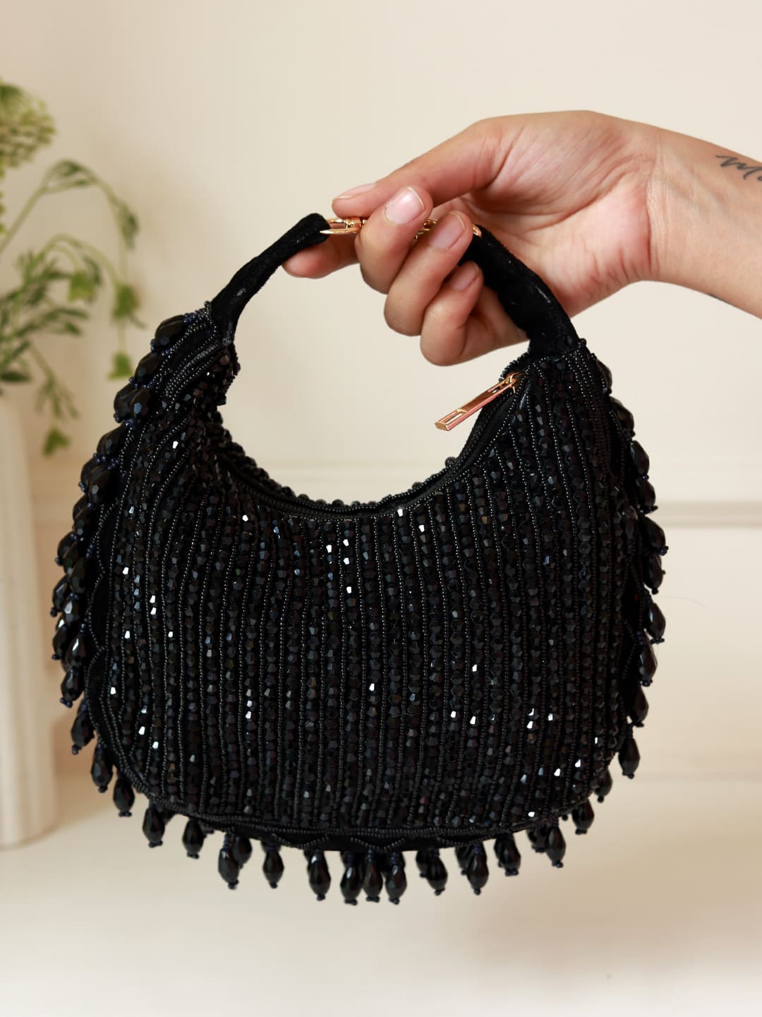 Black Sera Drop Pearls Batua Bag by The Tan Clan, showcasing elegant pearl embellishments and traditional Indian bag design.