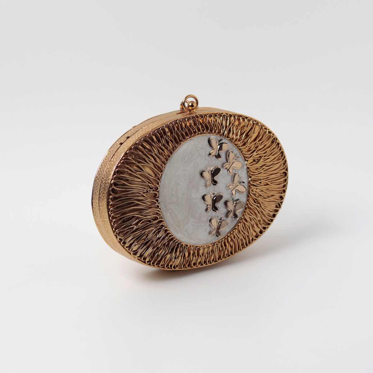 Elegant Titly wirework clutch by The Tan Clan featuring intricate design and mother of pearl accents.