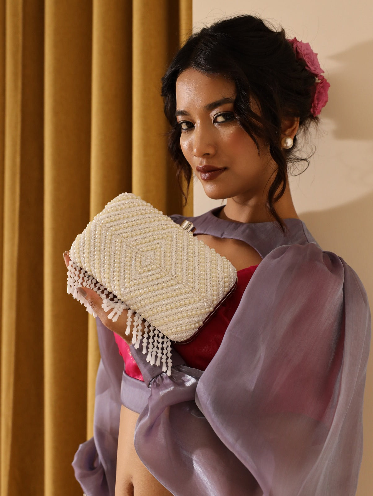 Pearly White hand-embroidered clutch bag from The Tan Clan with intricate floral embroidery on soft fabric.