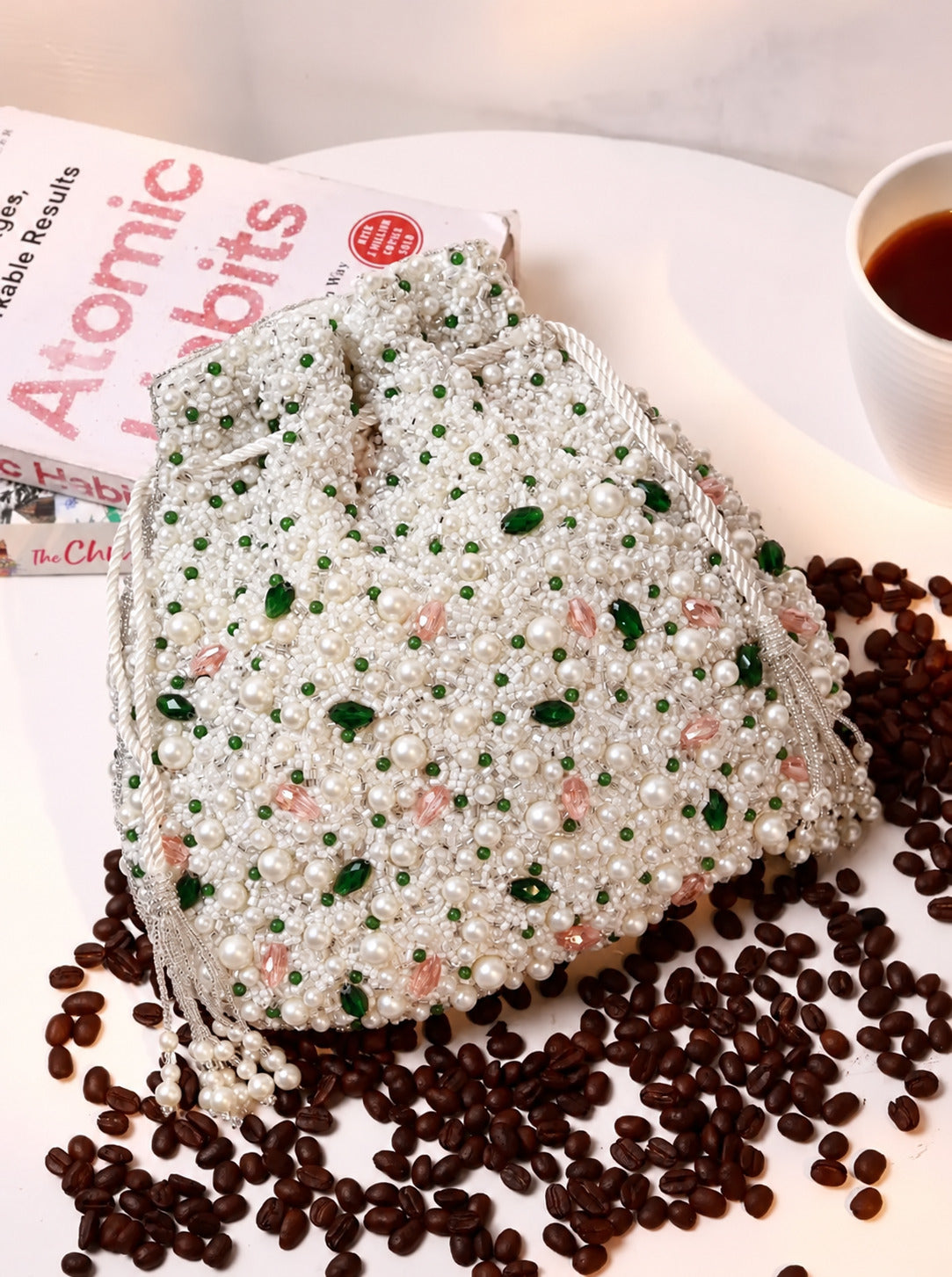 Ayra Pearl Potli Bag by The Tan Clan showcasing an elegant, embroidered pearl-embellished traditional Indian purse with a drawstring closure.