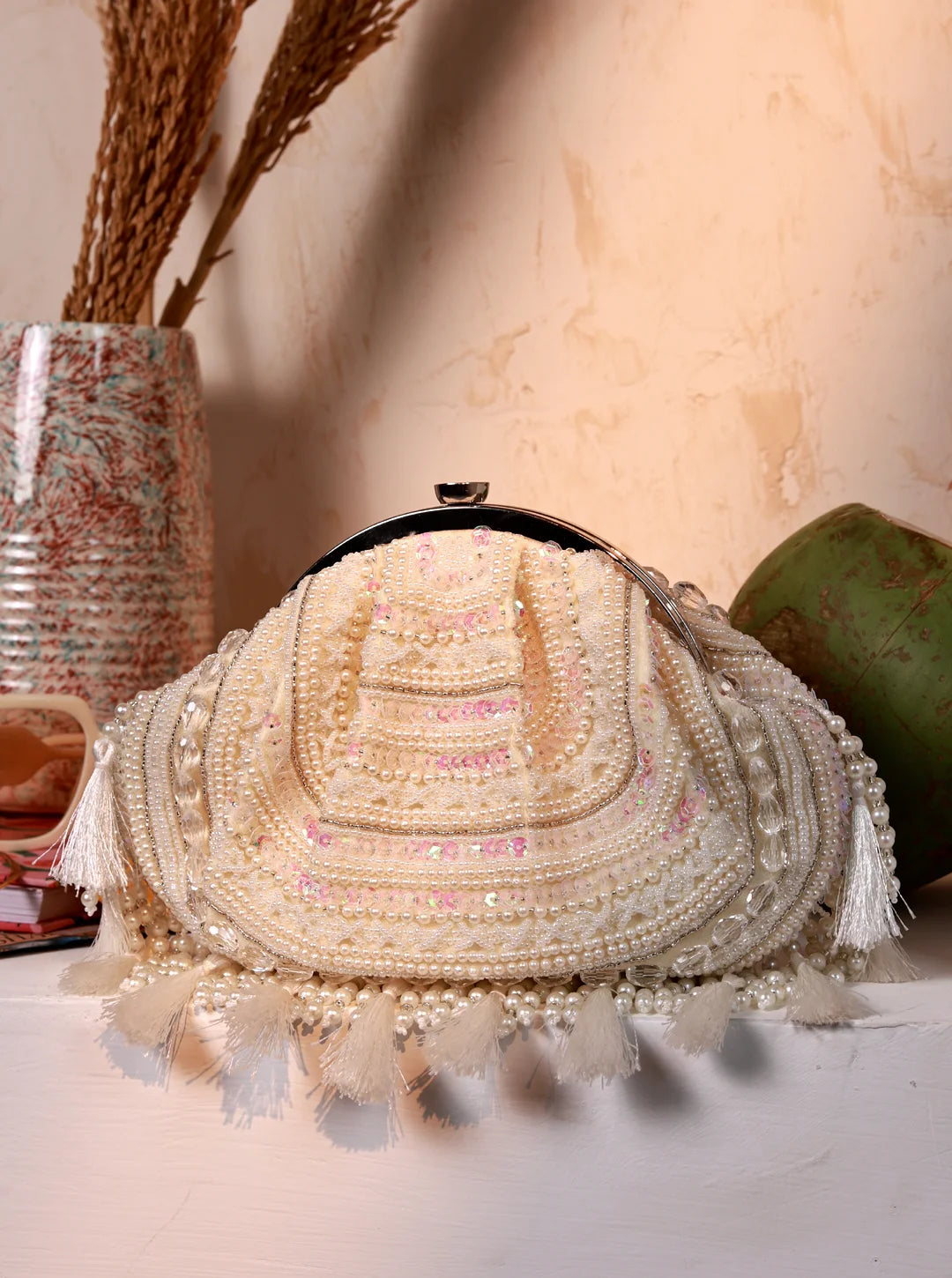 Tan Tan Clan Nora Tasselled Half Moon Batua Bag featuring tassels, half moon shape, and intricate design in natural leather.