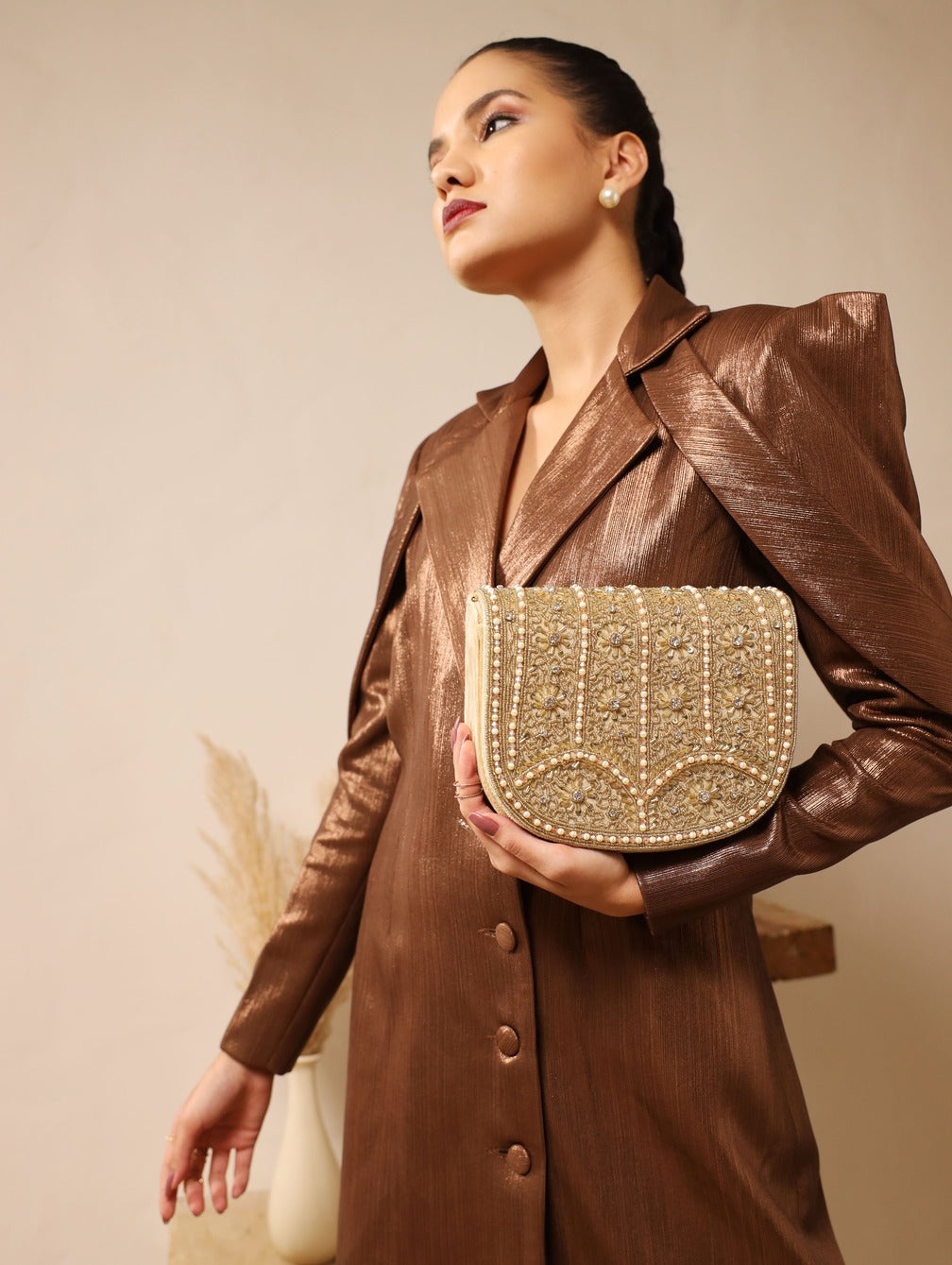 Kavya beige flap-over bag with handle from The Tan Clan, showing the stylish design and soft leather texture.