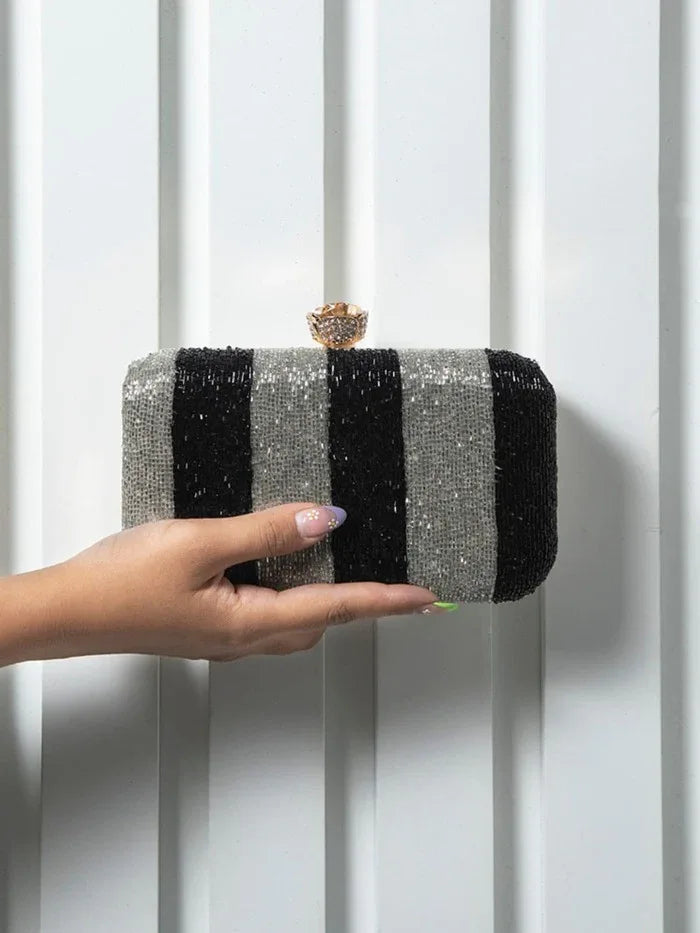 Afshaan hand embroidered clutch by The Tan Clan featuring intricate embroidery and a sleek design for elegant occasions.