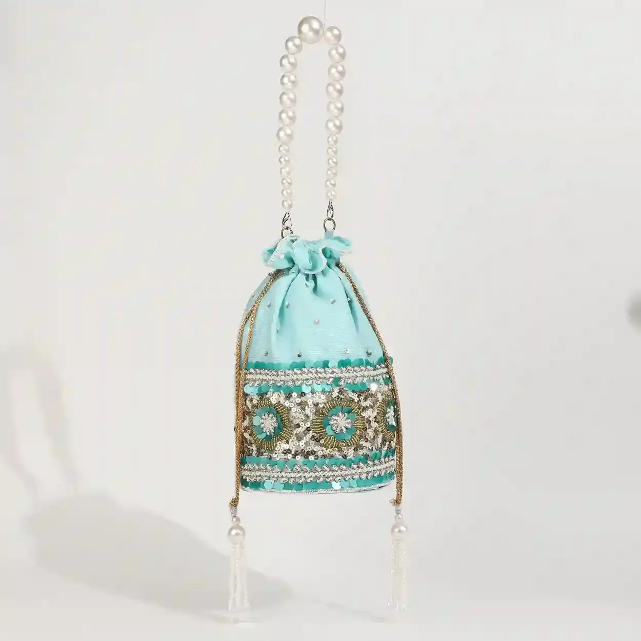 Ama Potli bag with pearl handle from The Tan Clan, featuring traditional design and elegant pearl accents.