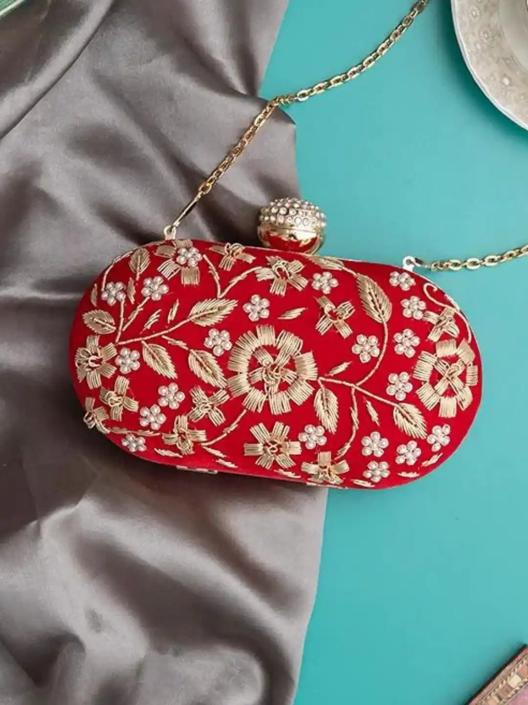 Two handcrafted Baiza Zardozi embroidered clutches by The Tan Clan with intricate gold and silver thread detailing.