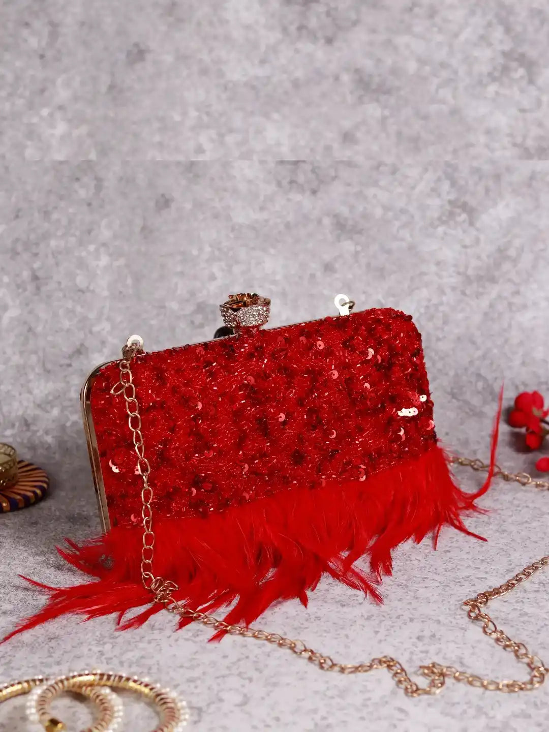 Red feather embroidered clutch bag by The Tan Clan featuring hand-stitched embroidery and elegant design.