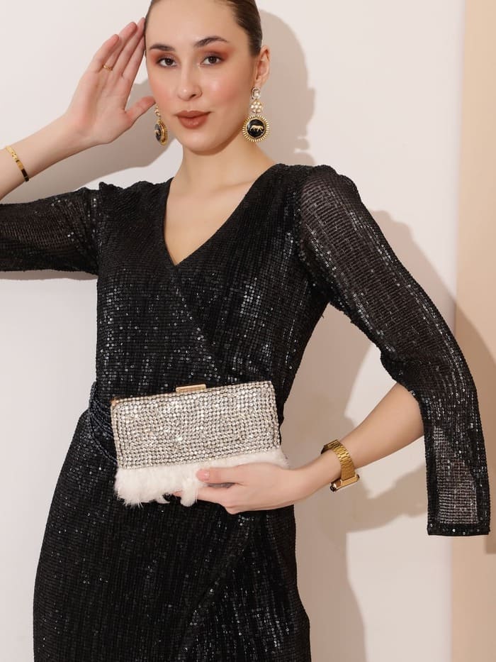 White feather clutch bag with hand embroidery by The Tan Clan, featuring intricate feather detailing and elegant craftsmanship.