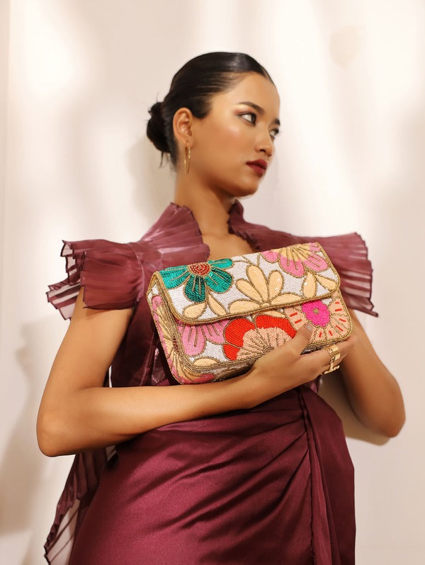 Daisy floral baguette bag with handle by The Tan Clan, featuring a colorful floral pattern and a sleek, compact design.