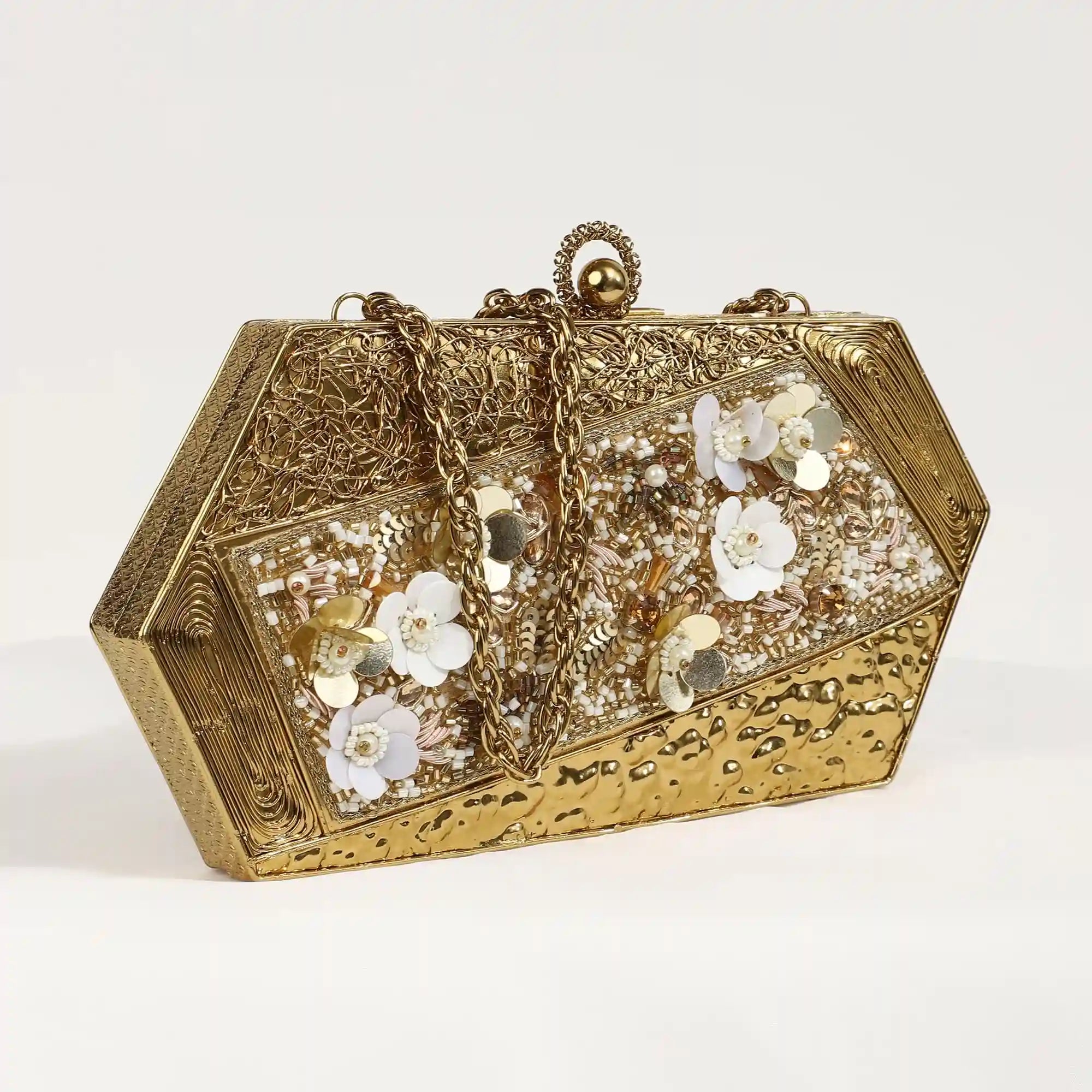 Gold embellished brass clutch purse featuring intricate details and a compact design, perfect for elegant occasions.