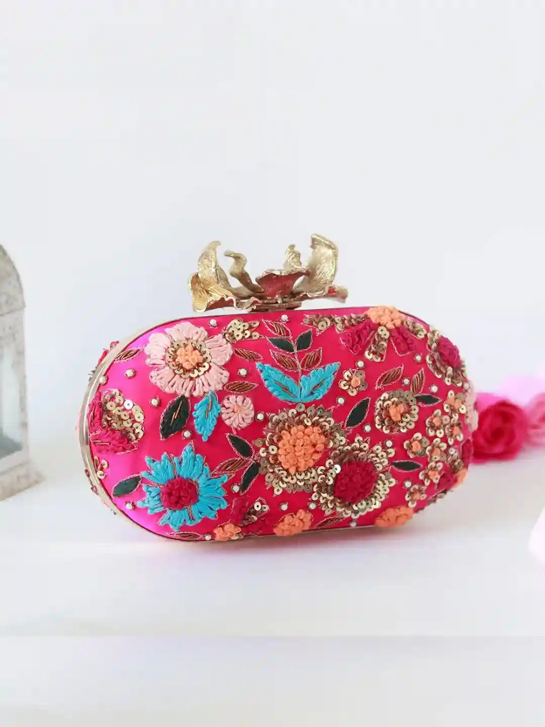 Flora Resham hand-embroidered clutch by The Tan Clan featuring intricate floral embroidery on fabric with a sleek design.