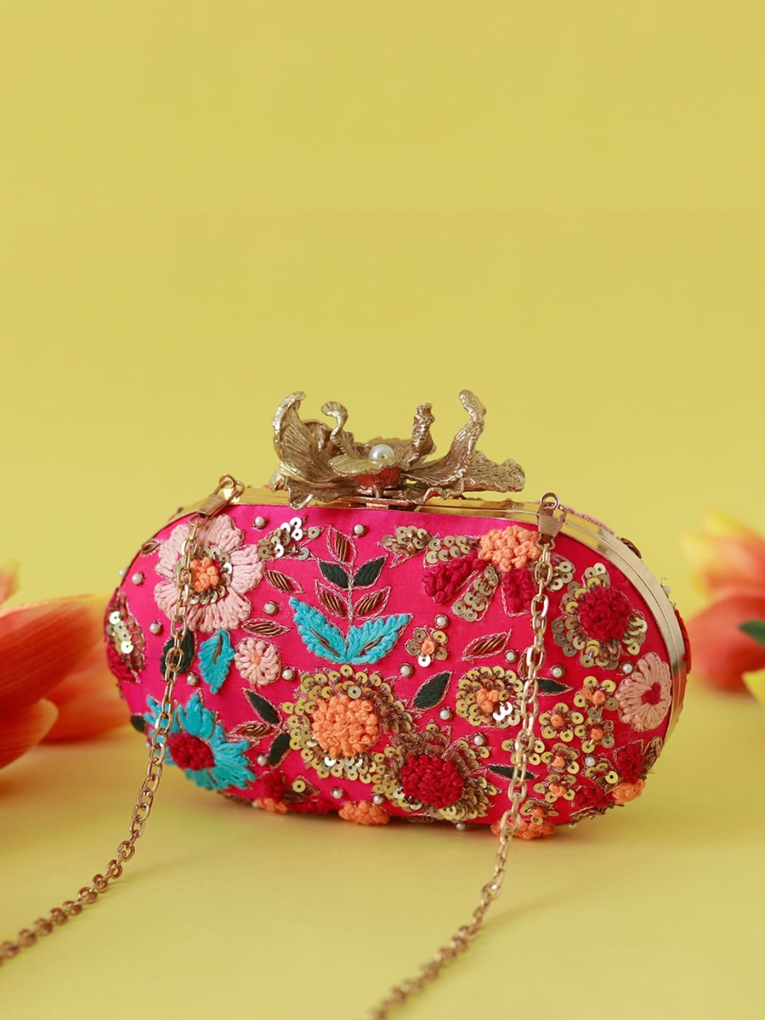 Flora Resham hand-embroidered clutch bag by The Tan Clan with colorful floral embroidery and a sleek design.