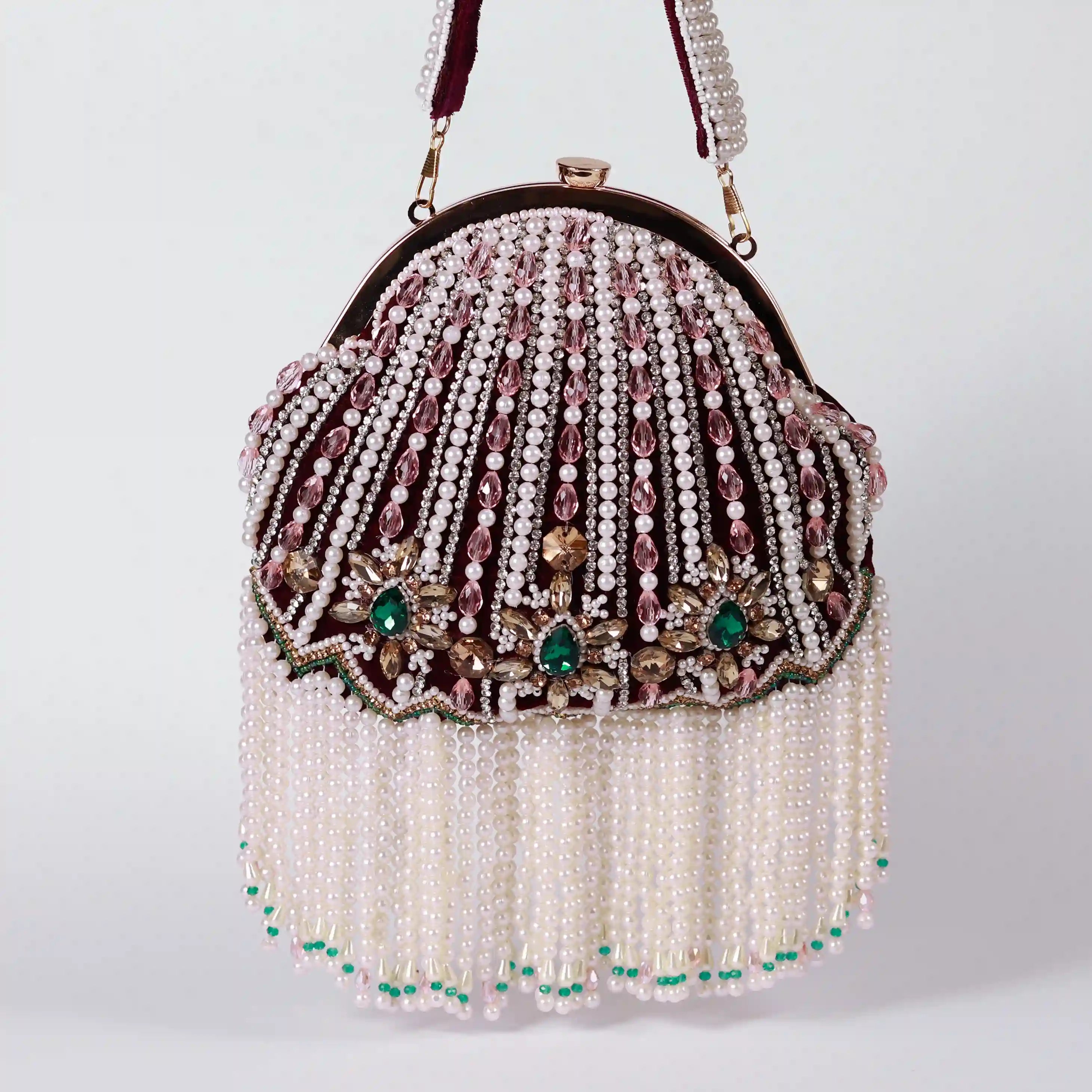 Maroon Frida Batua Bag by The Tan Clan featuring a detachable handle and stylish design, shown with its adjustable strap.