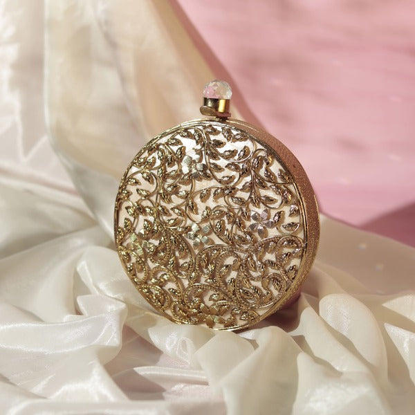 Intricate brass work with mother of pearl clutch by Gazal from The Tan Clan, showcasing detailed craftsmanship and elegant design.