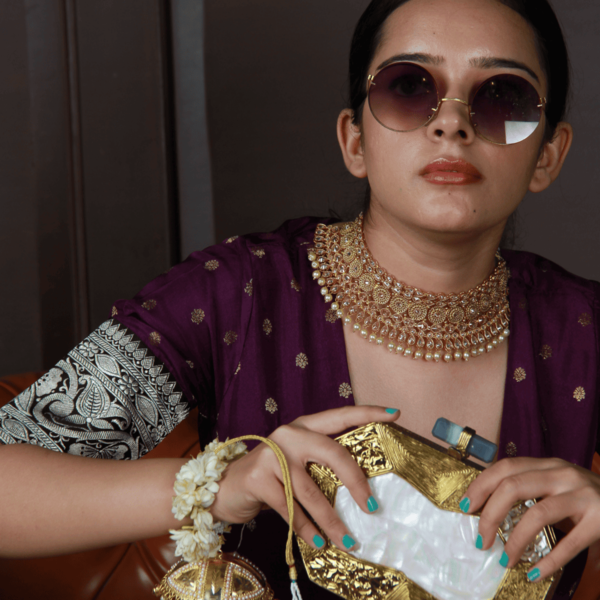 Intricate brass clutch with mother of pearl detailing by The Tan Clan, showcasing a traditional and elegant design.