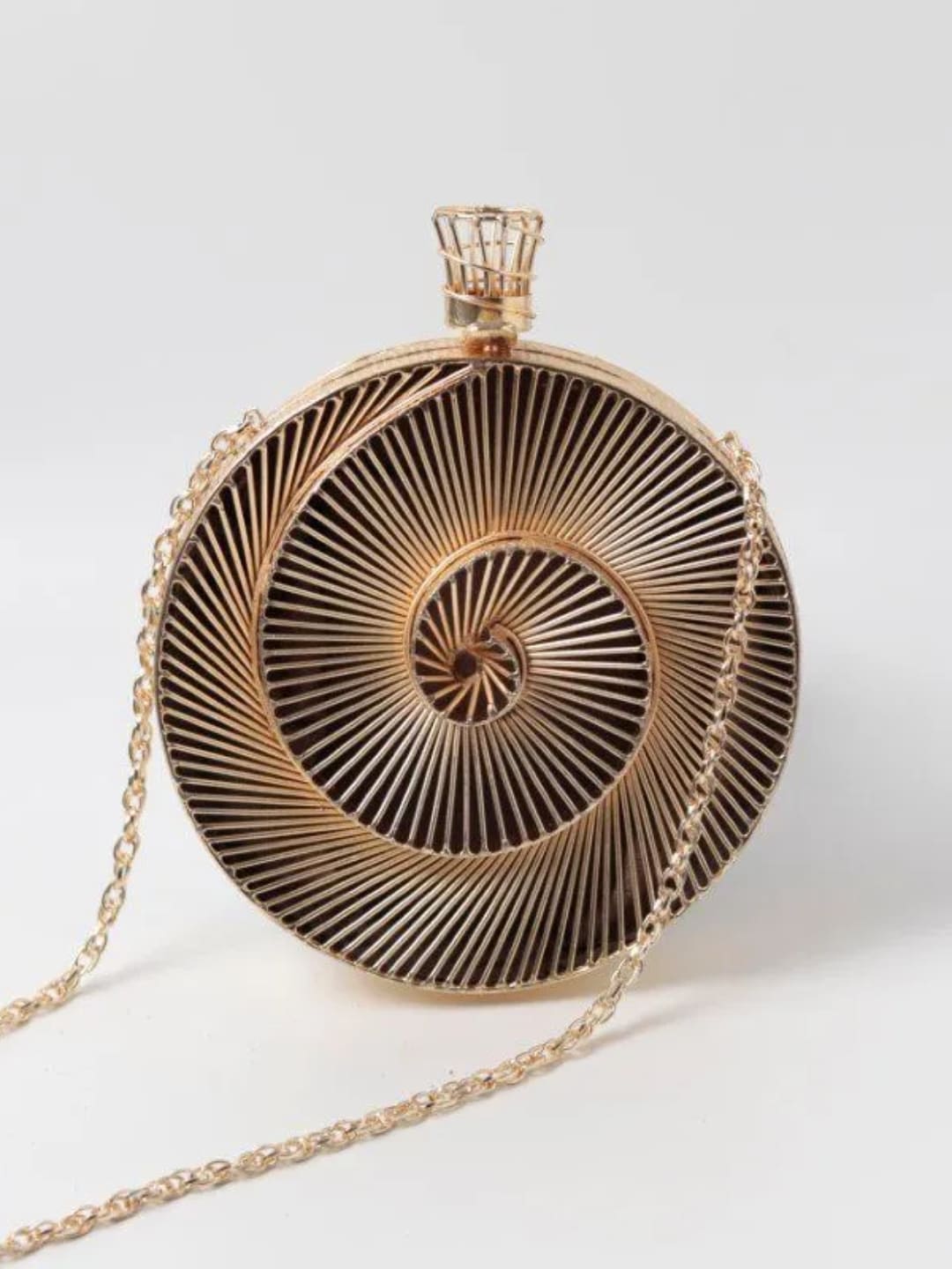 Isha brass wirework clutch by The Tan Clan with intricate metal detailing and handcrafted design, showcasing elegant craftsmanship.