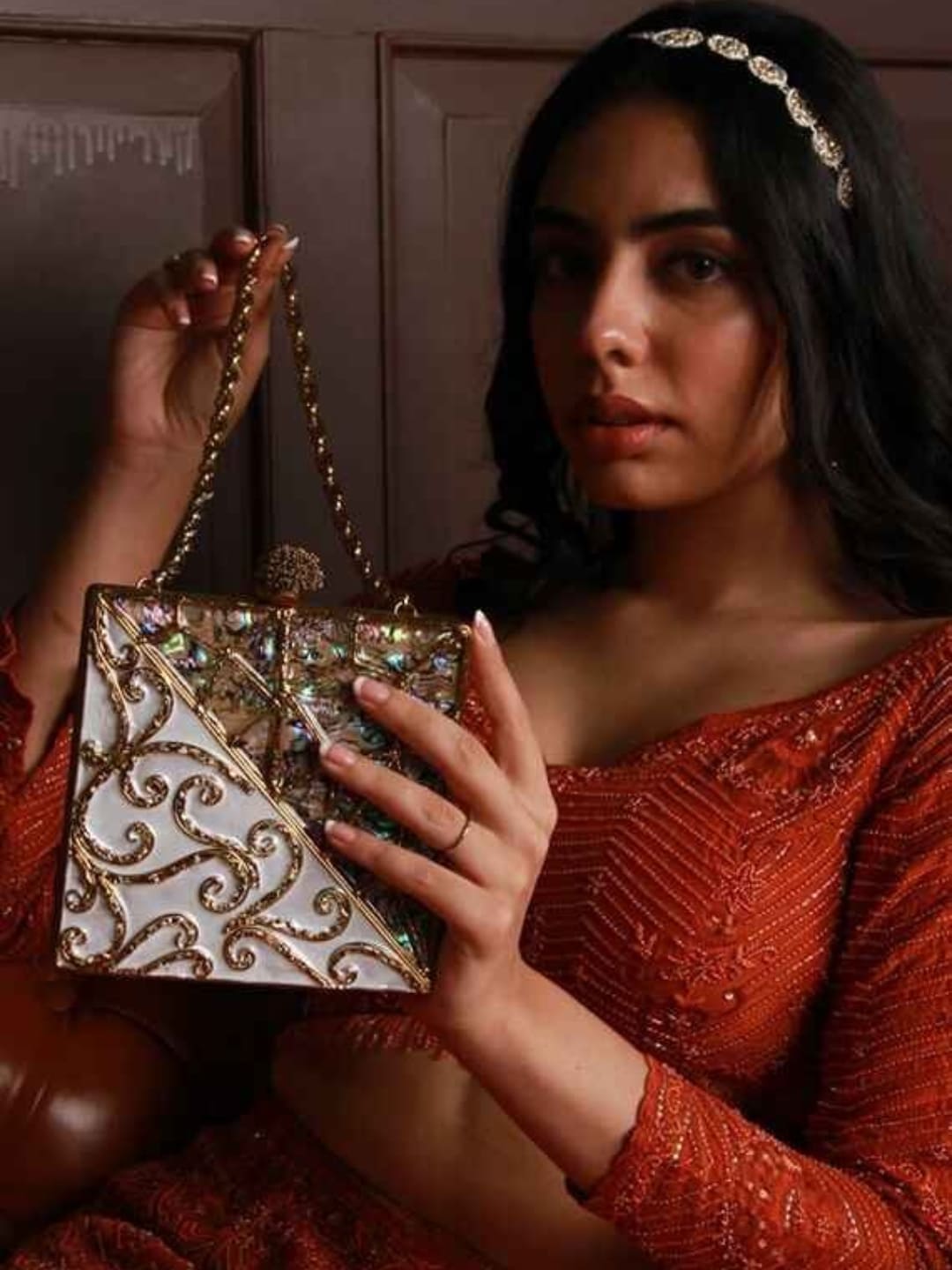 Lihaaz Mother of Pearl brass clutch by The Tan Clan, featuring intricate pearl inlay and a sleek compact design.
