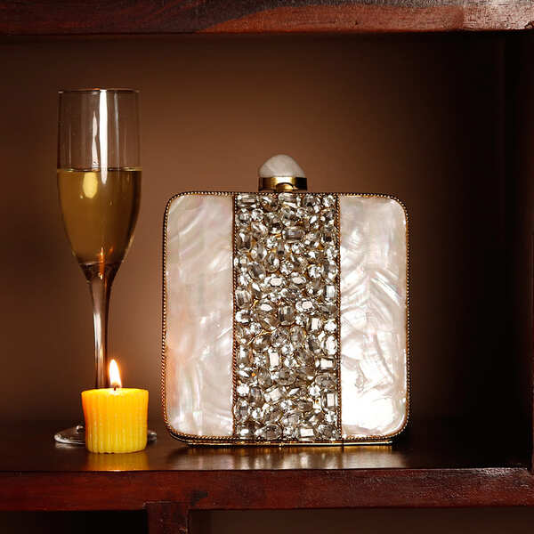 Liyana Mother of Pearl Clutch by The Tan Clan featuring iridescent pearl surface and elegant compact design.