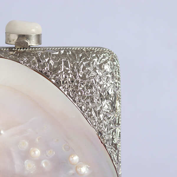 Elegant Mumtaz Mother of Pearl clutch by The Tan Clan with intricate pearl detailing and a sleek, stylish design.