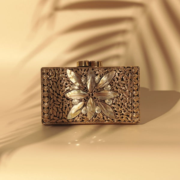 Nadia embellished mother of pearl clutch by The Tan Clan with intricate beadwork and a sleek, elegant design.