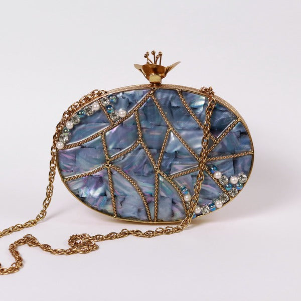 Nargis embellished mother of pearl clutch by The Tan Clan featuring intricate beadwork and a sleek rectangular design.