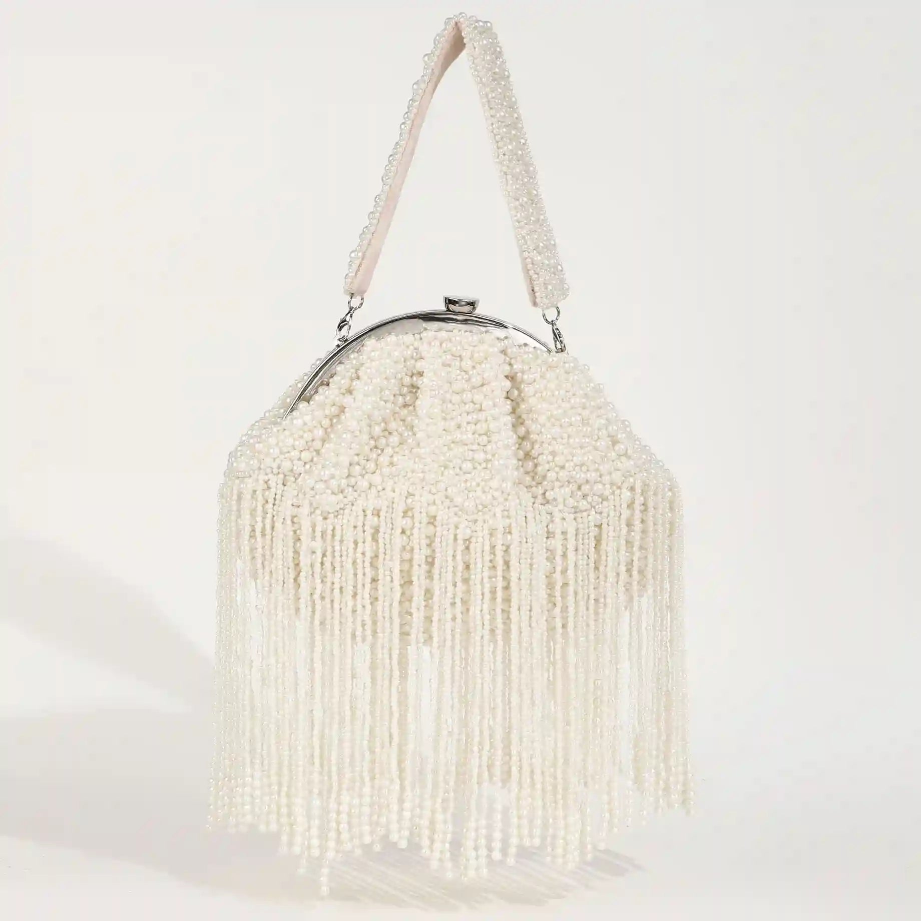 Pearl Batua bag with tassels from The Tan Clan, showcasing intricate design and decorative pearl embellishments.