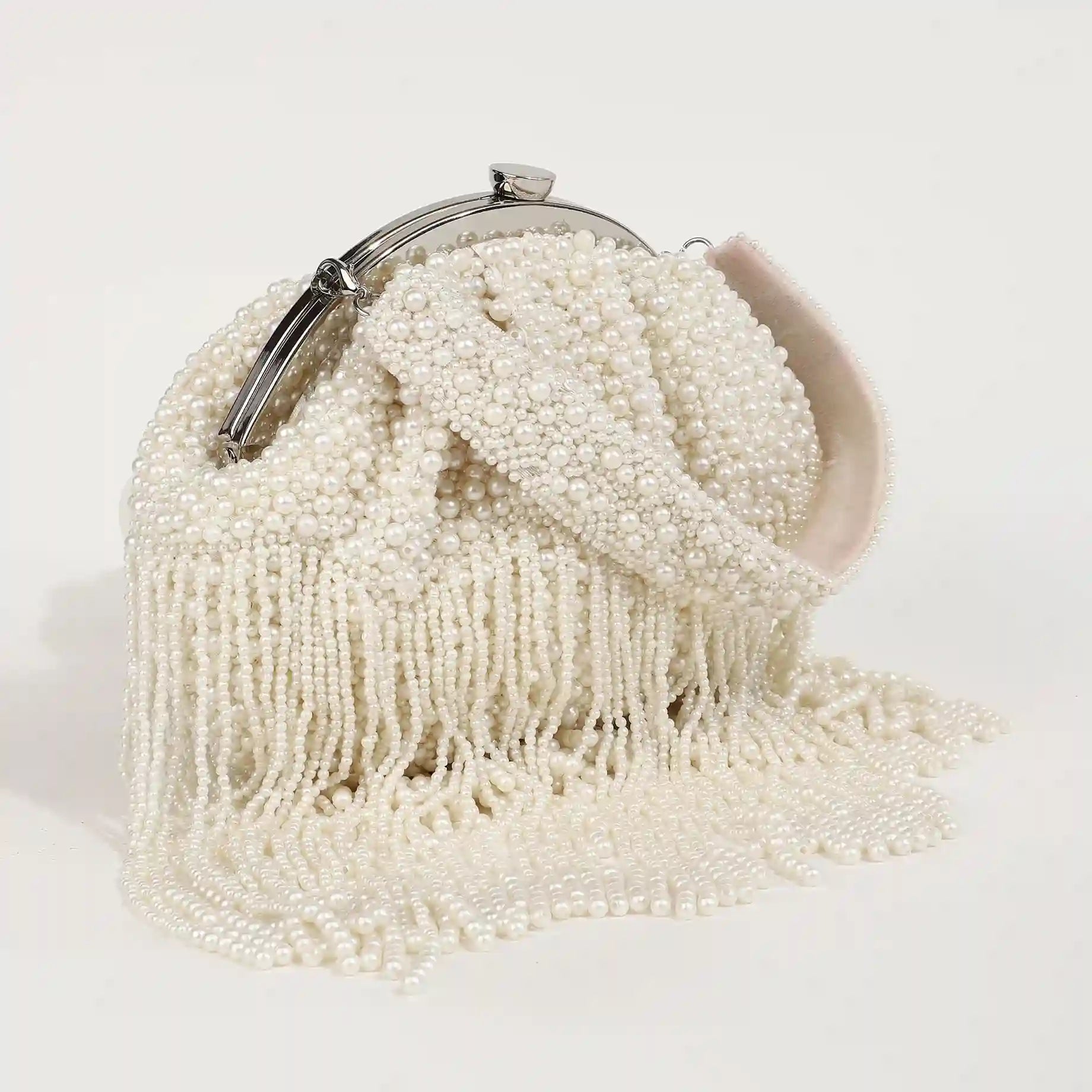 Pearl Batua bag with tassels from The Tan Clan, featuring a woven design and decorative pearl accents, ideal for traditional or casual wear.