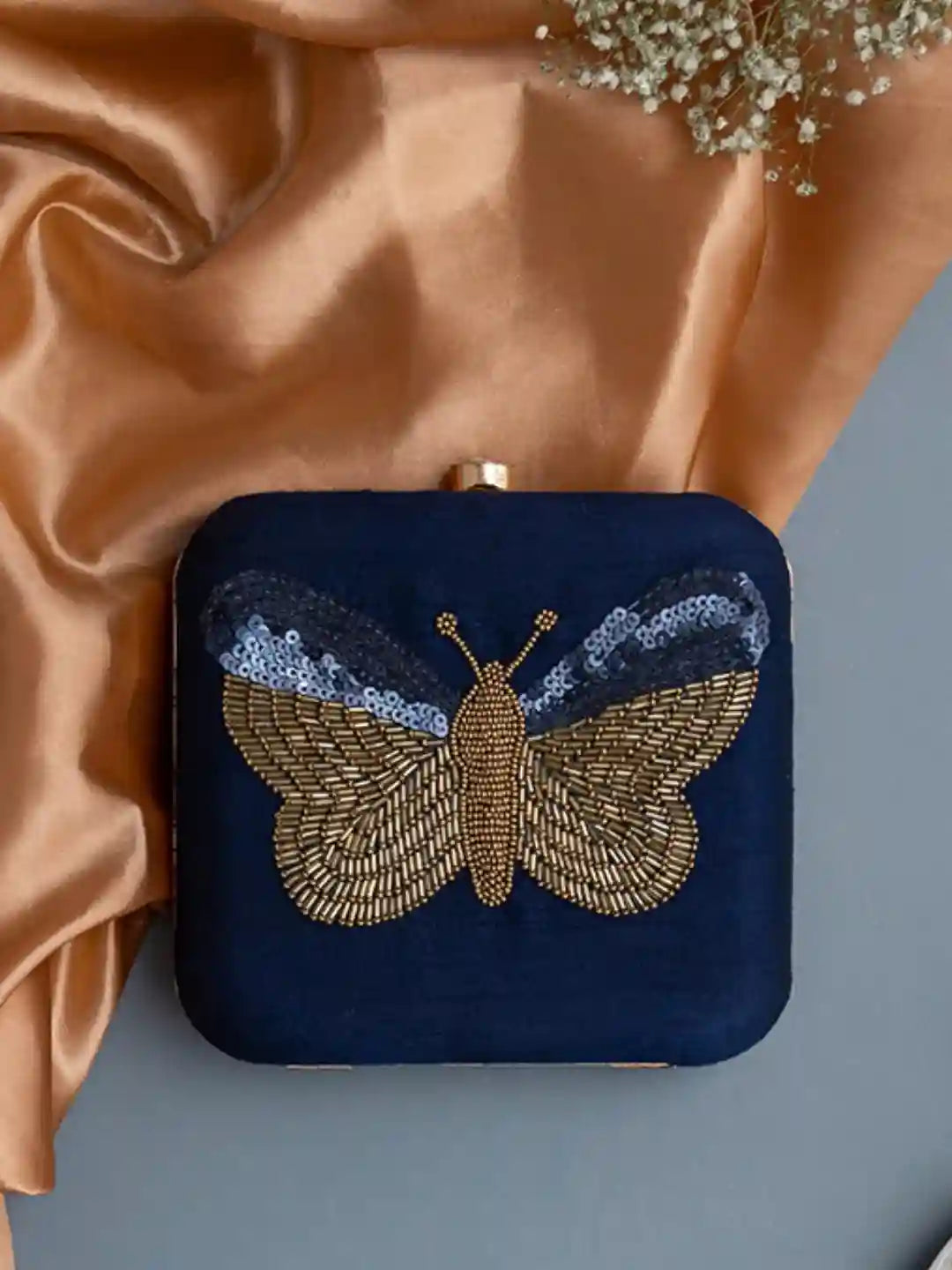 Square butterfly clutch purse with hand embroidery by The Tan Clan, featuring intricate butterfly designs on fabric.