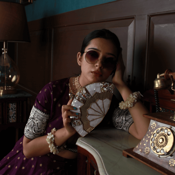 Golden brass clutch with mother of pearl accents from The Tan Clan, featuring a sleek, elegant design and intricate detailing.