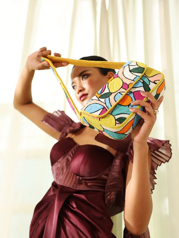 Multicolor Poppy Baguette Bag with handle from The Tan Clan, featuring vibrant patchwork and stylish design.