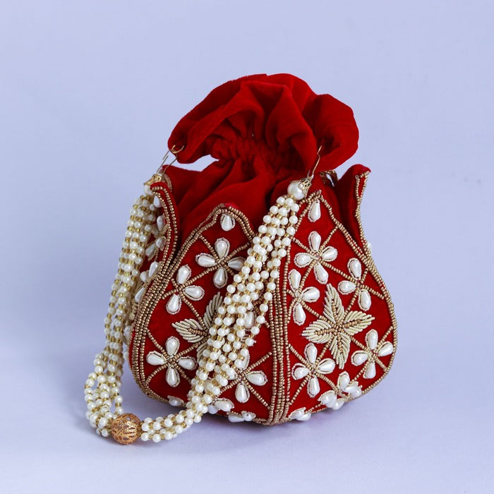 Hand embroidered Pushya mini lotus potli bag by The Tan Clan, featuring intricate embroidery and a compact, stylish design.