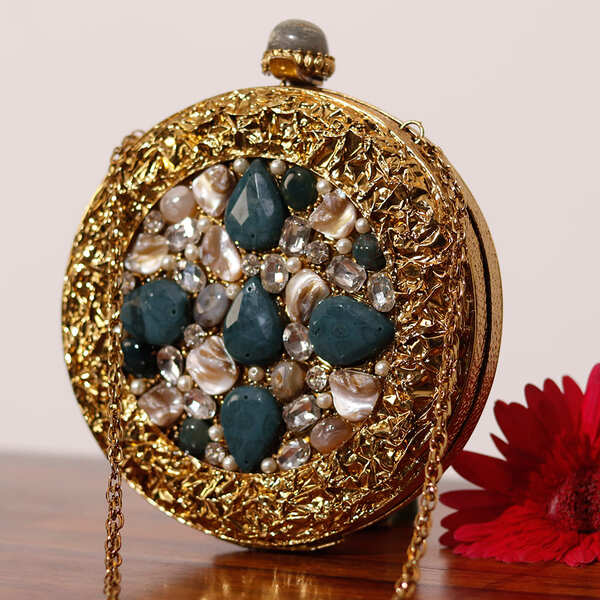 Qurbat embellished brass clutch by The Tan Clan featuring intricate design and decorative embellishments for elegant occasions.