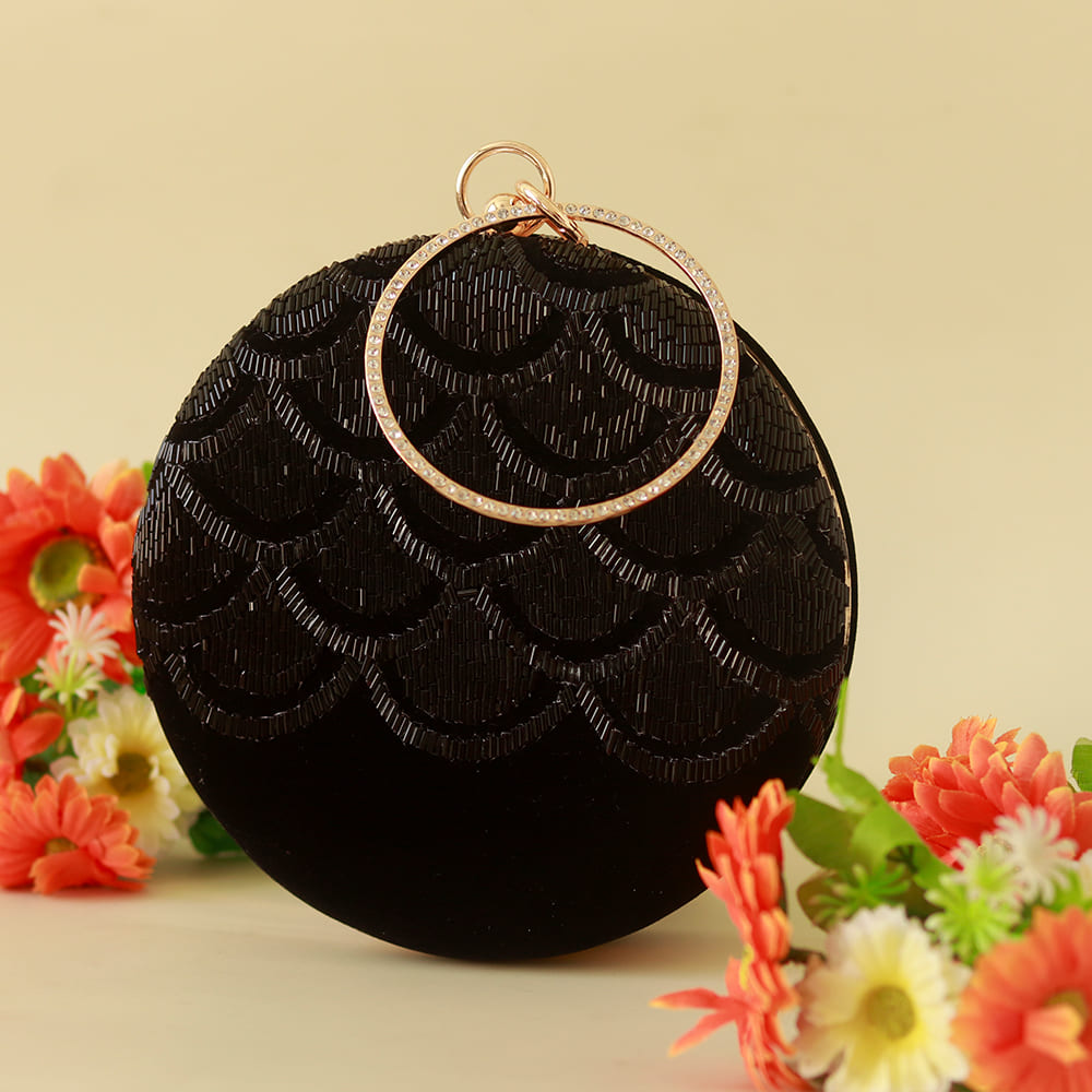 Black Rajwada hand-embroidered clutch bag with intricate traditional designs by The Tan Clan.