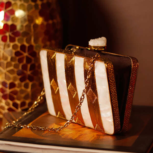 Riwayat Mother of Pearl clutch by The Tan Clan featuring intricate pearl accents and a sleek, elegant design.