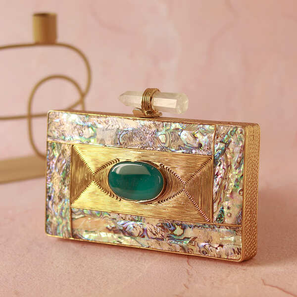 Golden brass clutch with intricate embellishments from Sahiba collection by The Tan Clan, featuring ornate design and elegant craftsmanship.